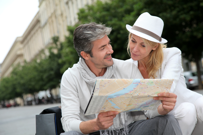 Mature couple examining a map while traveling on vacation