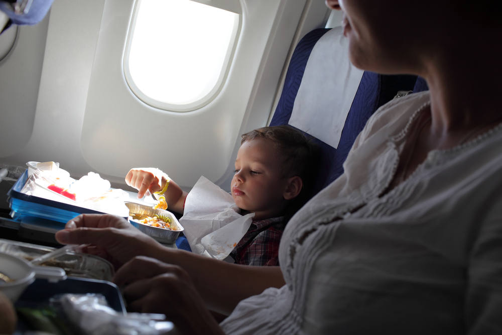Child eating in an airplane. 
