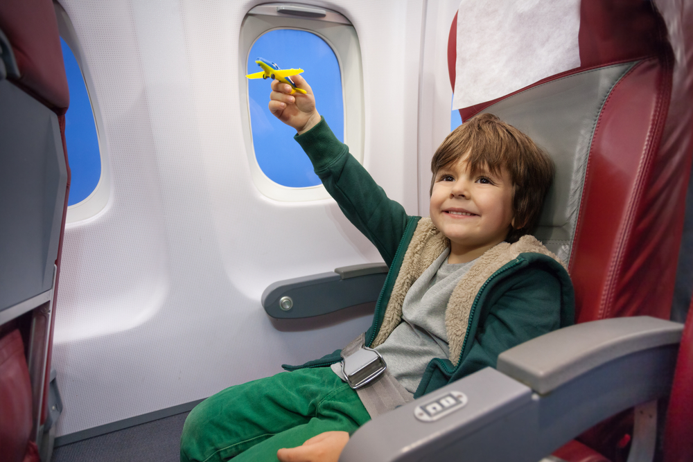 Child playing in an airplane. 
