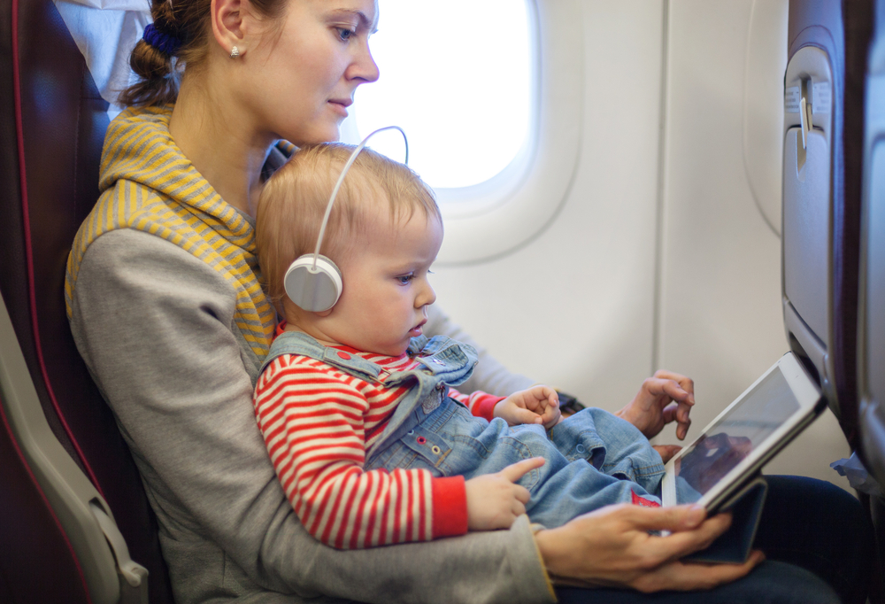 Child watching a video in an airplane. 