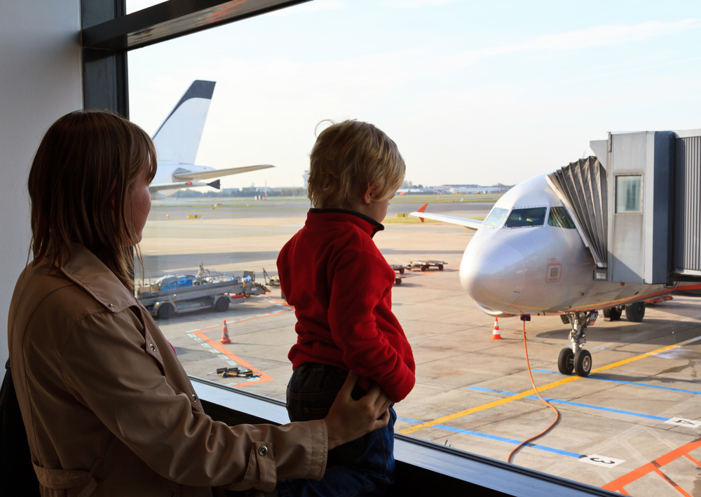 Mother and son looking at an airplane. 