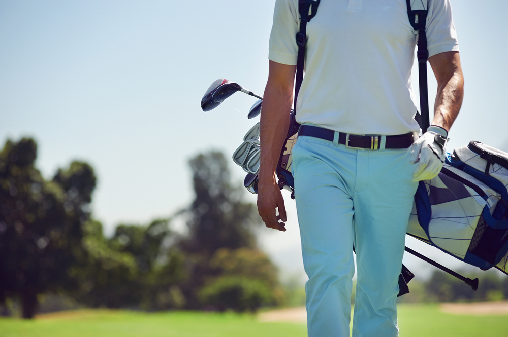 Man with golfing equipment